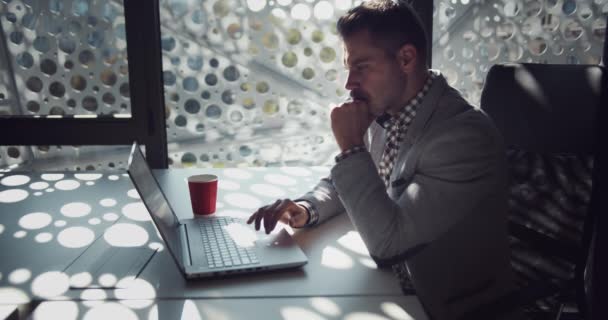 Empresário trabalhando no laptop no escritório moderno — Vídeo de Stock