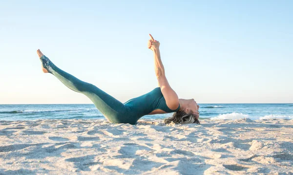 Kaukaski zdrowa kobieta z pięknym ciałem robi jogę na wschodzie słońca na plaży, Joga stwarza — Zdjęcie stockowe