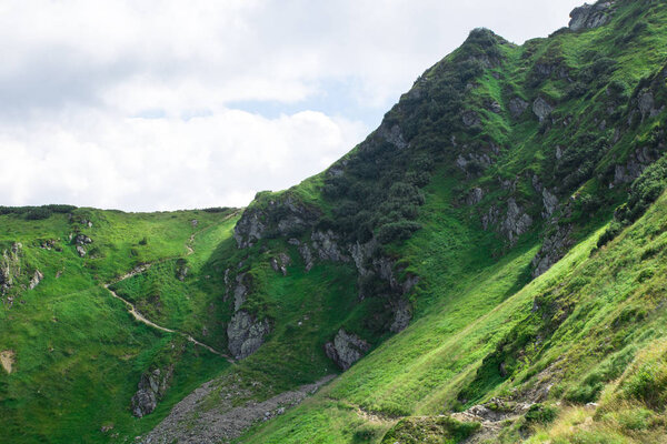 green mountain alps ridge, low gray clouds