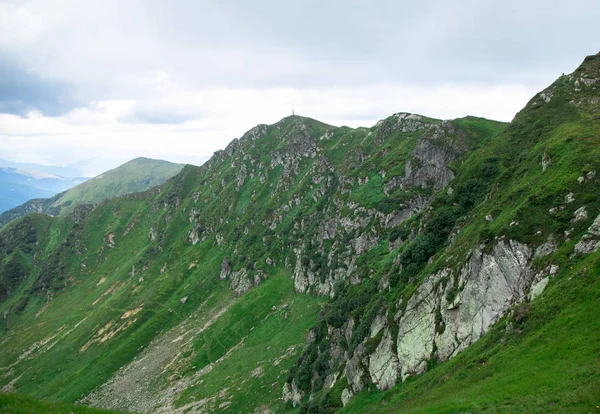 Green mountain alps ridge, low gray clouds — Stock Photo, Image