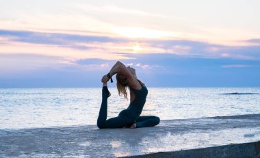 denizde gün doğumunda yoga böler yapıyor güzel vücut ile tanınmaz senoir kadın, yoga silueti pozlar