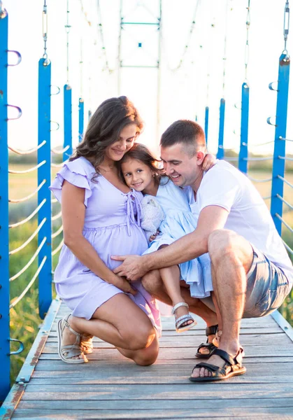 Happy Young Family Hugging Bridge Sunset Light Husband Little Girl — Stock Photo, Image