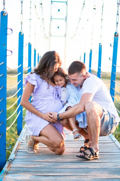 Happy Young Family Hugging Bridge Sunset Light Husband Little Girl — Stock Photo, Image