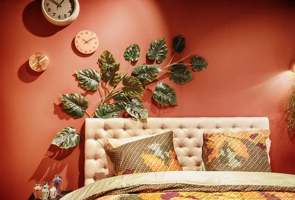 bed in interior with exotic plant as decoration