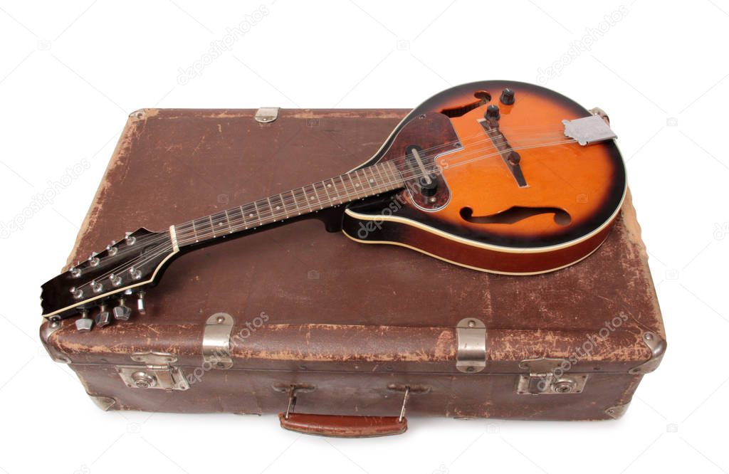 Old suitcase and mandolin in country style on a white background