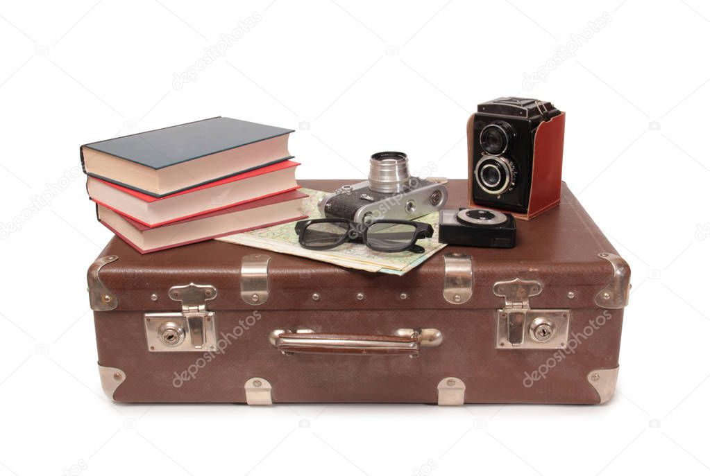 Vintage suitcase and old camera on a white background