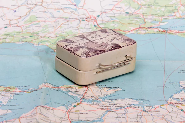 Suitcase for travel on paper map