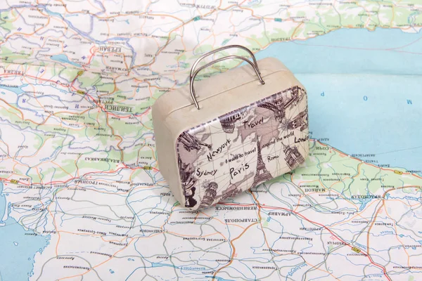 Suitcase for travel on paper map