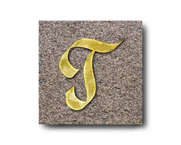 花岗岩板上英文字母的金色字母 — 图库照片