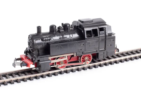 Steam train model on rails on a white background