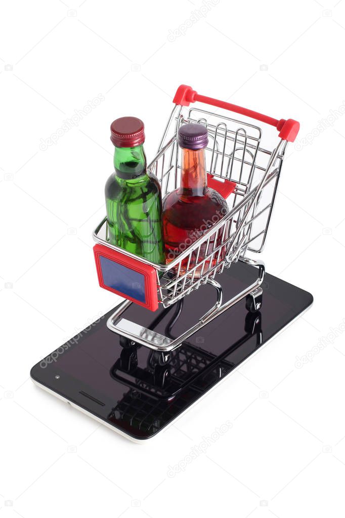 Metal cart whit bottle from store and smartphone on a white background