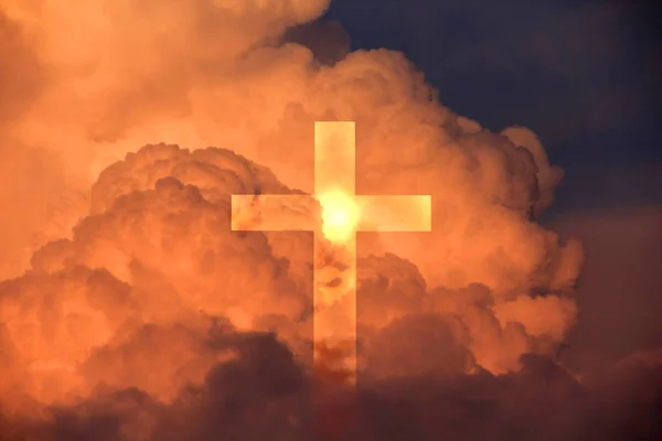 Cross from the blue sky against a background of dark clouds