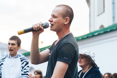 Eylül, 1, 2018 - Minsk, Beyaz Rusya: adam mikrofon şarkı bir grup insan önünde sokakta