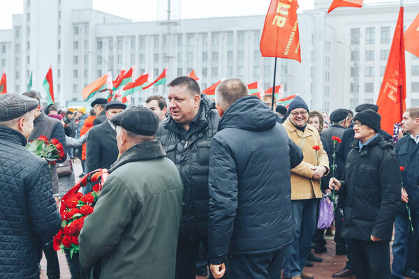 November 7, 2018 - Minsk, Belarus: Anniversary of Great October Socialist Revolution, group of people standing on square with flags