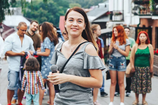 21 Temmuz 2018 - Minsk, Beyaz Rusya: mikrofon standları önünde birçok insan sokakta kadınla