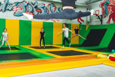 February 9, 2019 - Minsk, Belarus: Training in trampoline hall. Girls jump in trampoline hall clipart