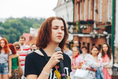 21 Temmuz 2018, Minsk, Beyaz Rusya Street yürüyüş kadın bir mikrofon ile bir sokak konserde söylüyor