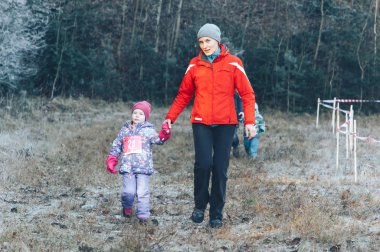 17 Kasım 2018 Logoisk Belarus Beetle-trail 8 Logoisk Mom ve küçük kızı ormanın yakınındaki patikada koşuyor