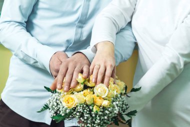 December 1, 2018 Minsk Belarus The bride and groom put their hands with wedding rings put on their fingers on the marriage registration book. clipart