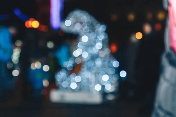 Blurred background of colorful lights of a luminous figure.