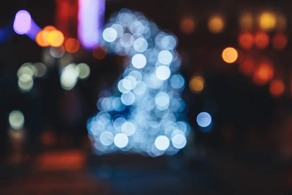 Blurred background of colorful lights of a luminous figure.