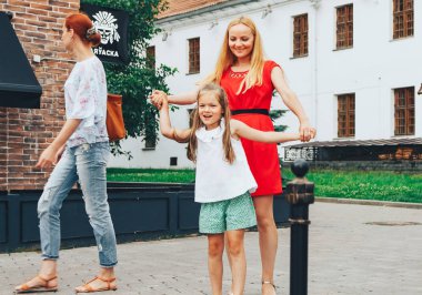 21 Temmuz 2018 , Minsk,Belarus Caddesi küçük kızıyla birlikte anne yürüyor sokakta oynuyor