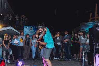 1 Eylül 2018 Minsk Beyaz Rusya sokak şenlikleri akşam şehrin bir adam bir keman ile insanların önünde sokakta oynuyor