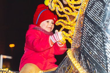 30 Aralık 2018 Minsk Belarus Yeni Yıl kutlamaları şehir meydanında. Parlayan bir atın üzerinde oturan küçük kız Kapat