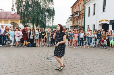 21 Temmuz 2018, Minsk, Beyaz Rusya Street yürüyüş kadın bir mikrofon ile bir sokak konserde söylüyor