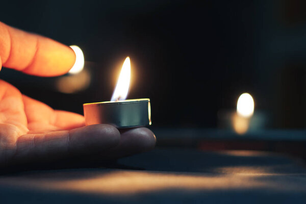 Holocaust Remembrance Day The hand holds a candle on the day of remembrance.