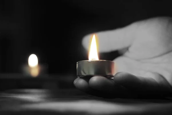 Holocaust Remembrance Day The hand holds a candle on the day of remembrance.