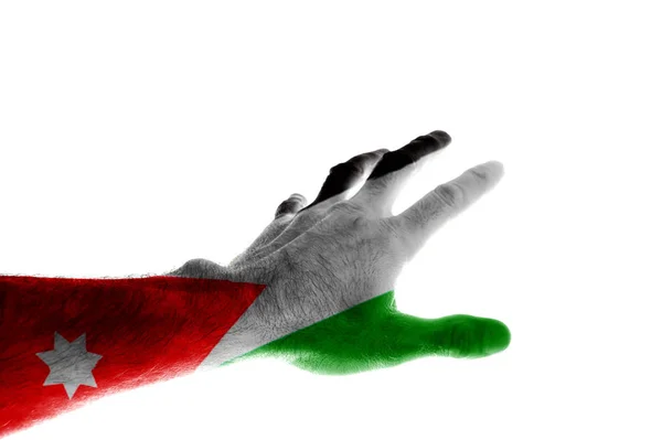 The hand of a mature man painted in the colors of the Jordanian flag stretches forward with his fingers spread Image dedicated to the accession of the King of Jordan to the throne on June 9 Isolated on white background.