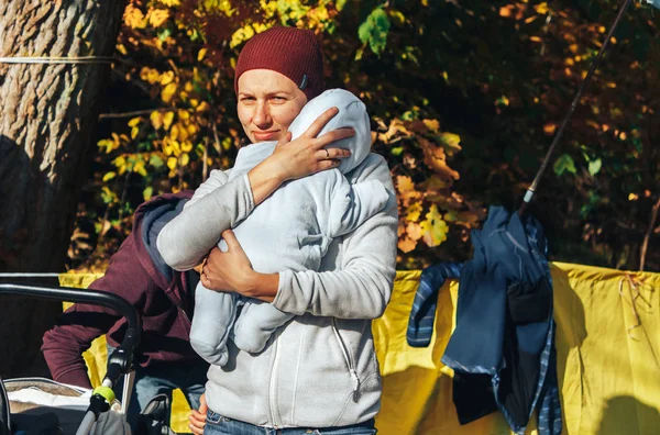 14 Ekim 2018, Minsk, Belarus.2018 Medvezhino Olimpiyat Kros Kupası Xco kollarında küçük bir çocuk ile bir kadın sonbahar ormanında duruyor