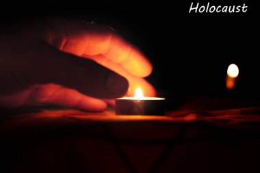 Anma Günü Uluslararası Holokost Anma Günü Yazıt Holokost'un sağ üst köşesinde ölülerin anısına mum yanıyor