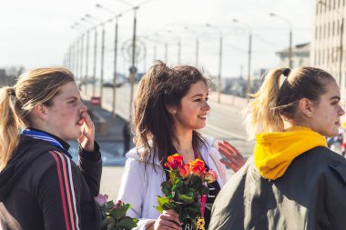 8 Mart 2019 Minsk Belarus Kadınlar Günü Yarışı 8 Mart'ta üç güzel genç kız sokakta duruyor. Kız eliyle burnunu siliyor..