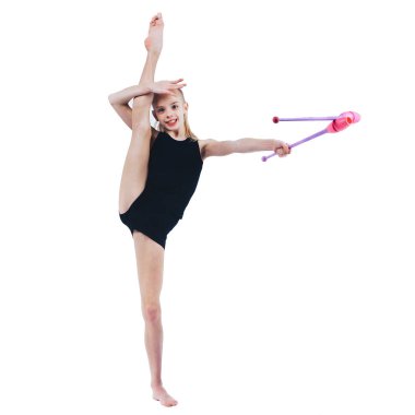 Standing young gymnast doing splits, holding maces for gymnastics