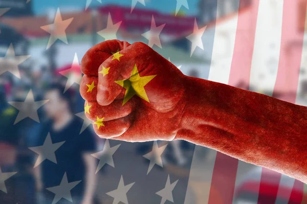 China\'s expansion into the US market Concept of a man\'s hand painted in the colors of the flag of China