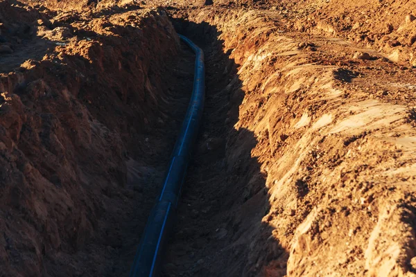 Tubo di plastica dell'acqua giaceva in una trincea — Foto Stock