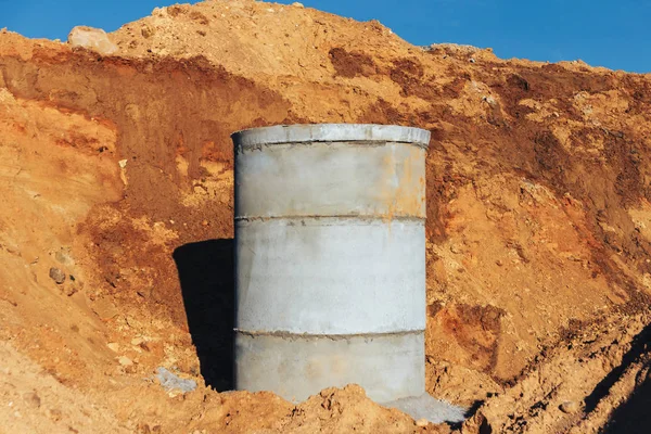 Concrete well at the construction site for water pipes