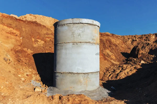 Concrete well at the construction site for water pipes