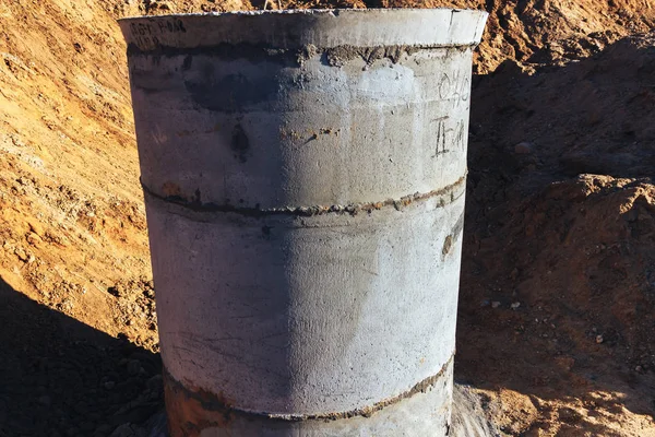 Construction site concrete well for water pipes