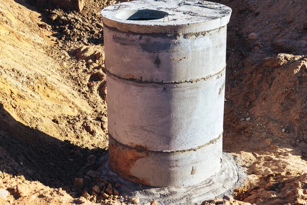 Concrete well at the construction site for water pipes