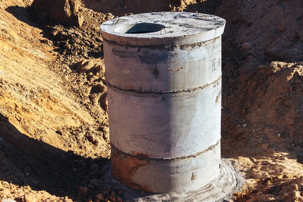 Concrete well at the construction site for water pipes