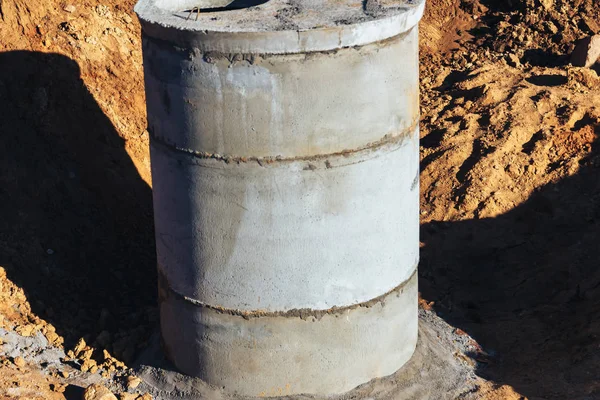 Concrete well at the construction site for water pipes