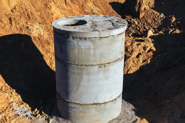 Concrete well at the construction site for water pipes and sewage