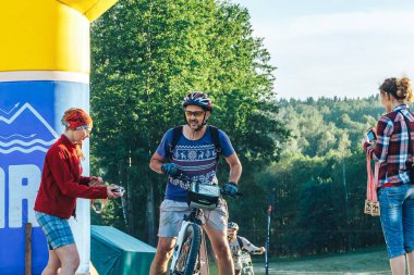 26-27 Mayıs 2018 Naliboki, Belarus Belarus amatör maratonu Naliboki madalyalı insanlar bitiş çizgisinde bir bisikletçiyle karşılaştı..