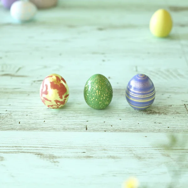 Trois œufs de Pâques colorés sur bois vert — Photo