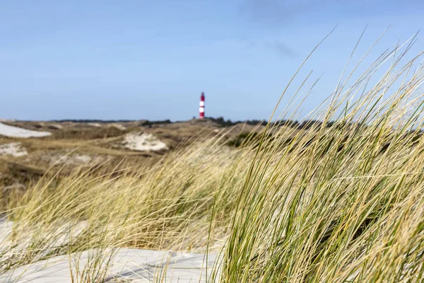 Red and white lighthouse on a hill on Amrum — Stock Photo, Image