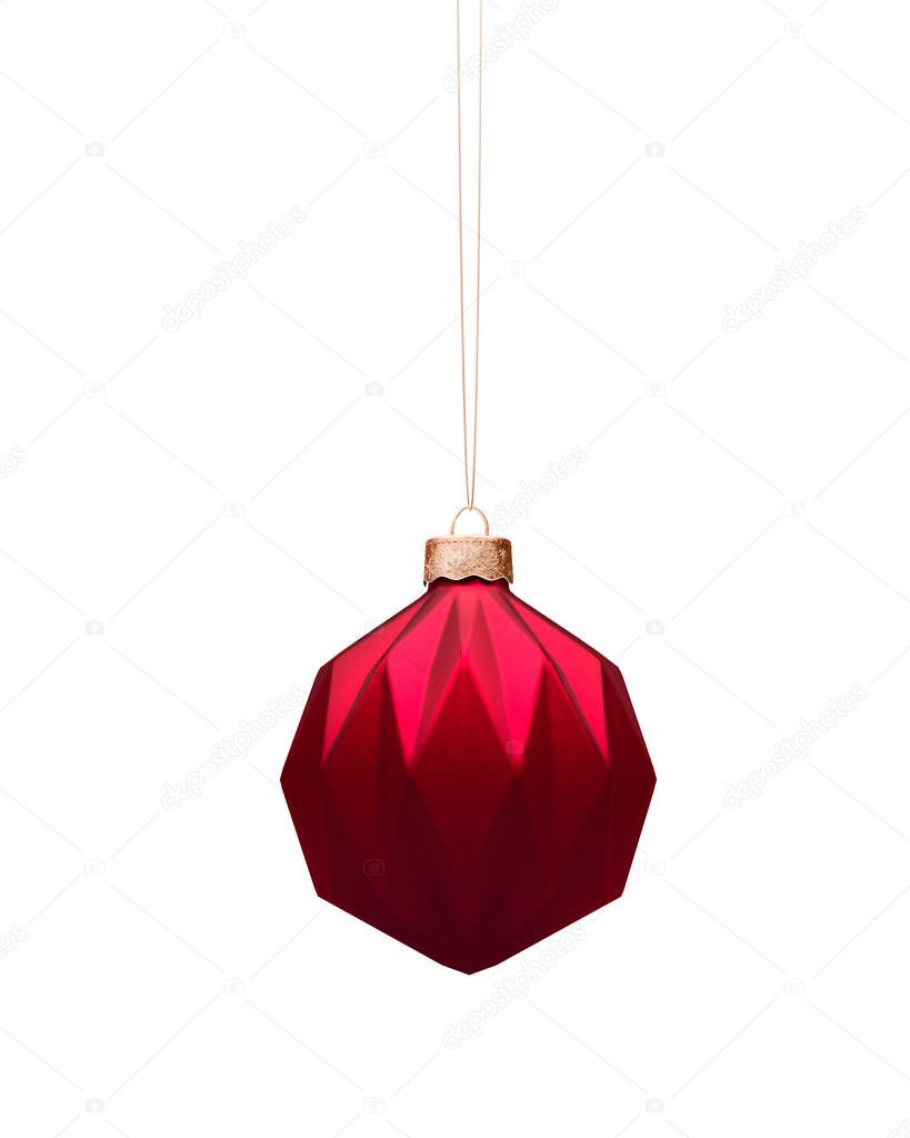 Matt red Christmas ball with modern geometric pattern. Top light. Isolated on white background. Christmas decoration, festive atmosphere concept.