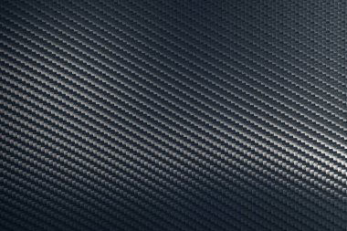 Çapraz yönelimli gri dokuma karbon fiber kompozit doku. Geleceğin hafif hammaddesi. Modern teknoloji ve malzeme konsepti